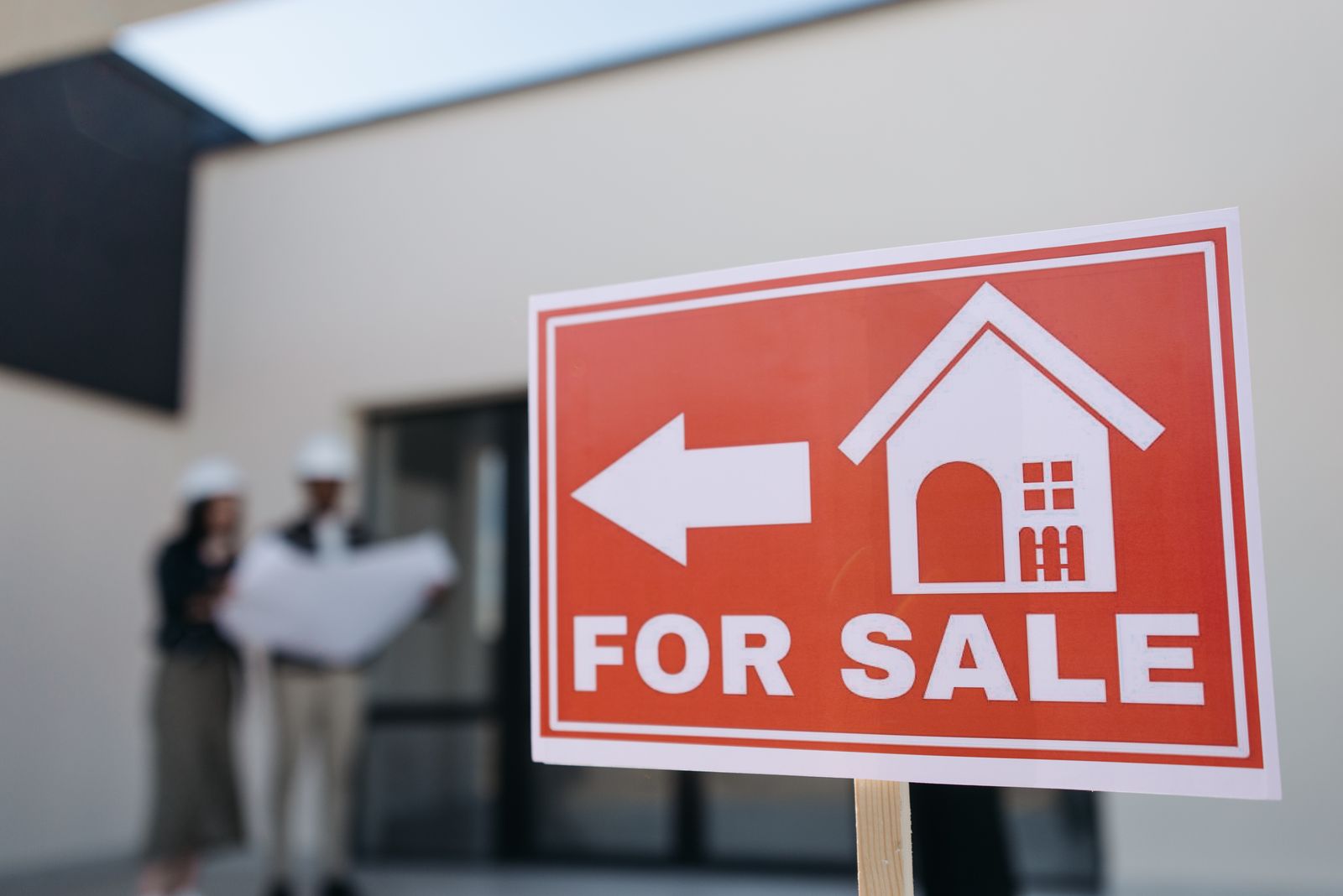 A red "For Sale" real estate sign in front of a home, representing the Red Deer real estate market
