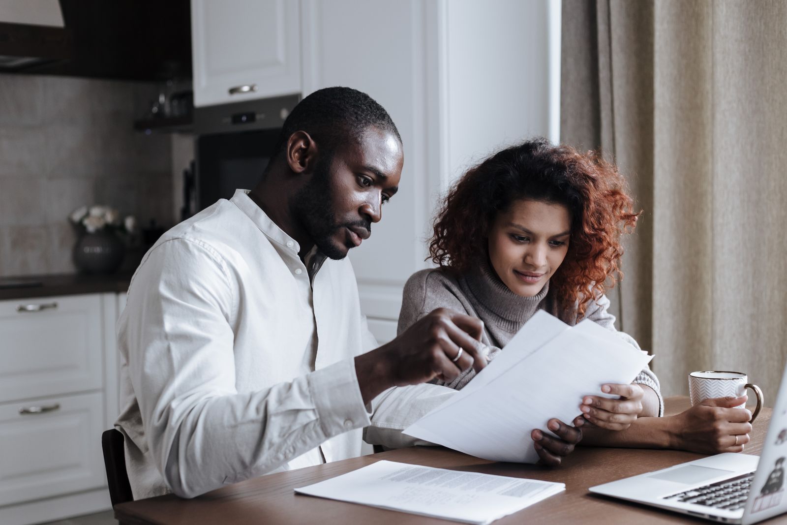 Couple using a mortgage calculator to plan buying a home in Red Deer